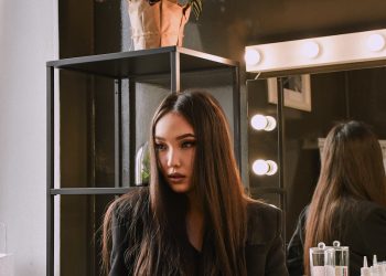 woman in brown leather jacket sitting on chair
