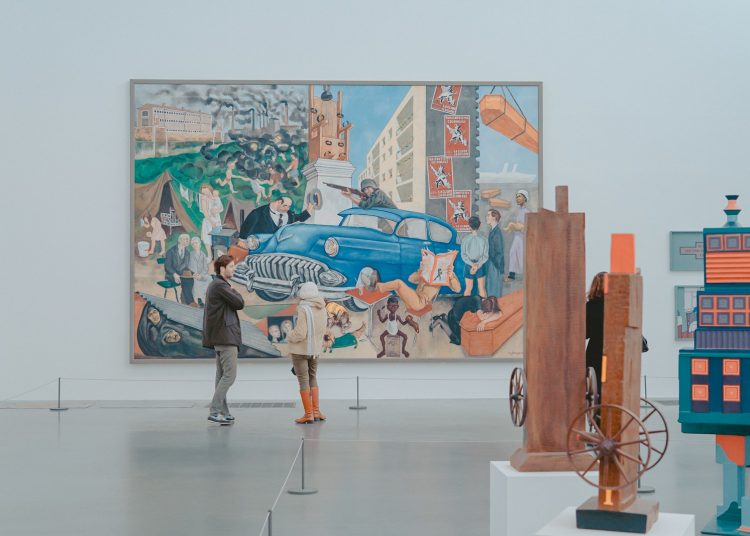 man and woman standing in front of painting in gallery