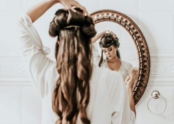 woman wearing white dress standing in front of mirror